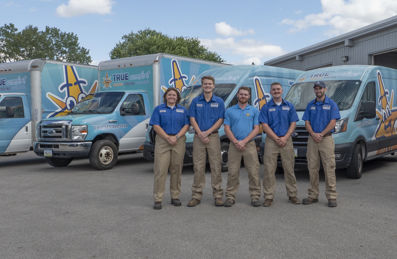 The True Comfort crew standing in front of the company's service fleet