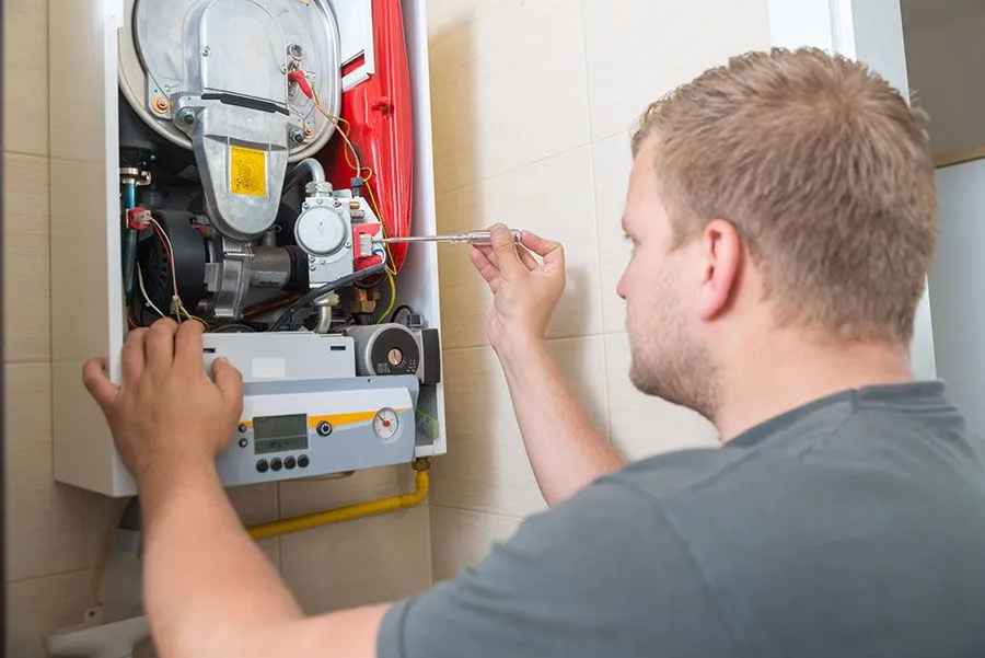 technician repairing gas furnace 1920w