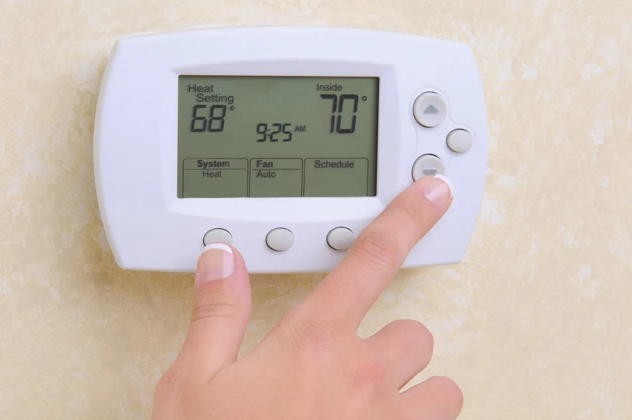 CloseupofHandandThermostatstockphoto 1920w