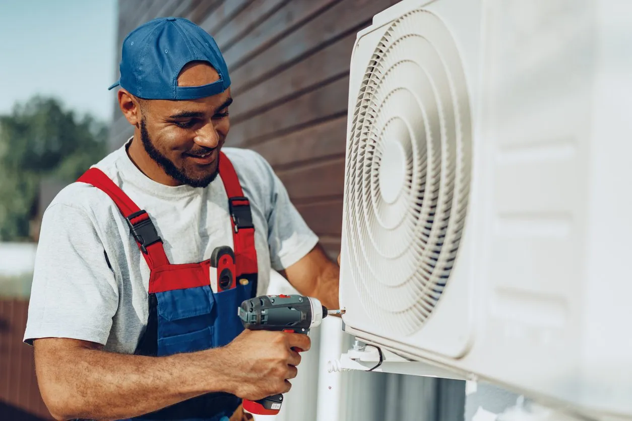 Repairmaninuniforminstallingtheoutsideunitofairconditionerstockphoto 1920w