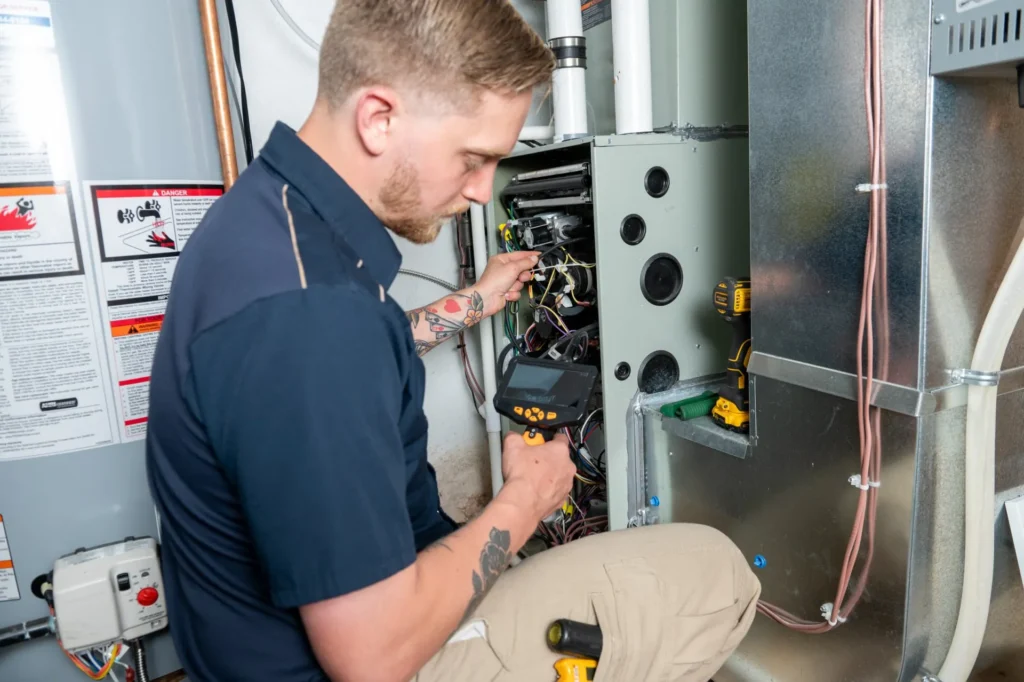 A person working on plumbing services in Des Moines, IA
